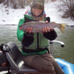 Angler holds rainbow trout caught while fly fishing the Colorado River