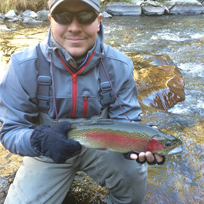 Angler with Rainbow trout at Grandpa's Retreat