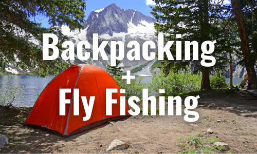 a red tent set up near an alpine lake in rocky mountain national park