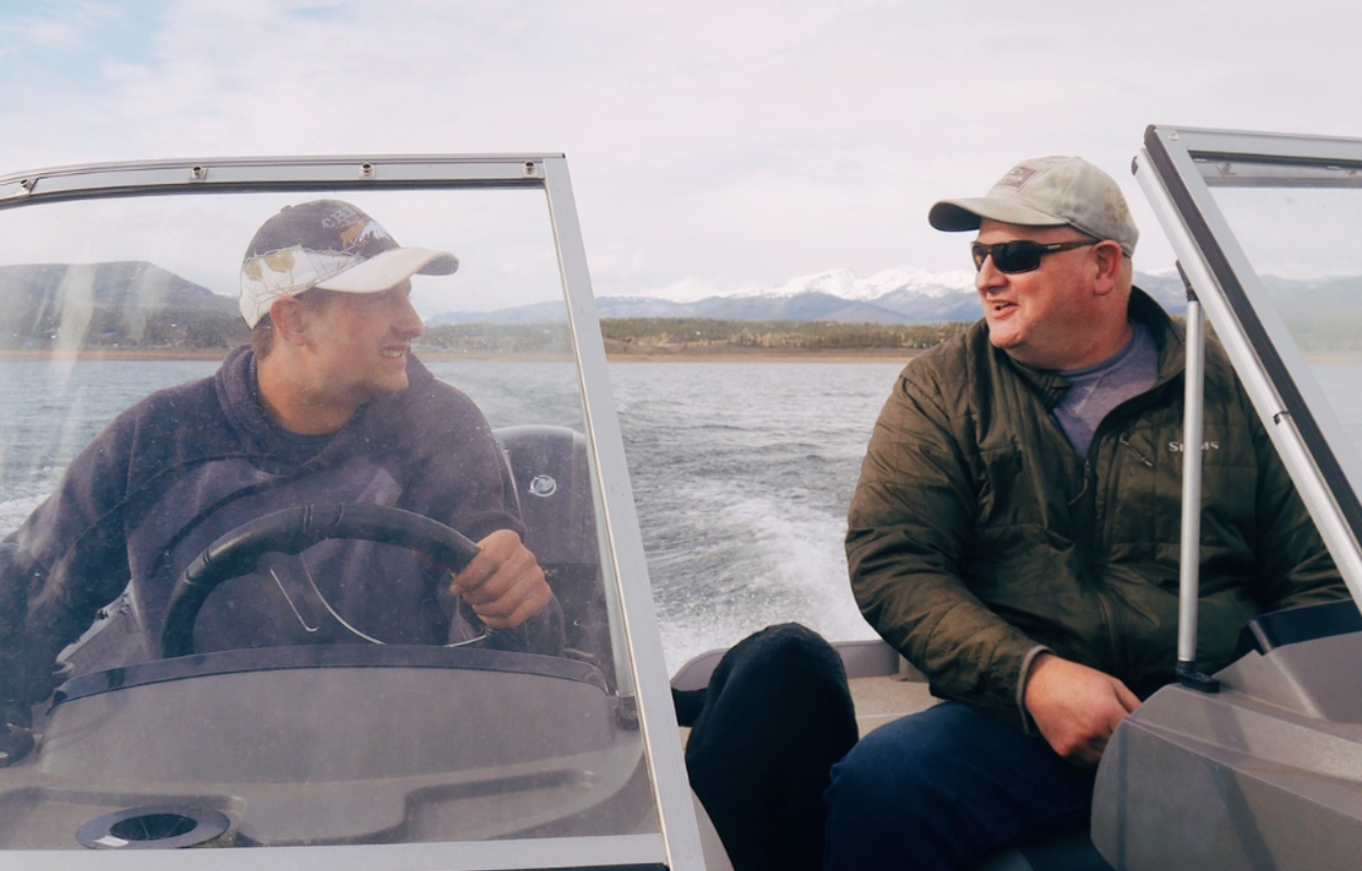 two men on a boat talking to each other