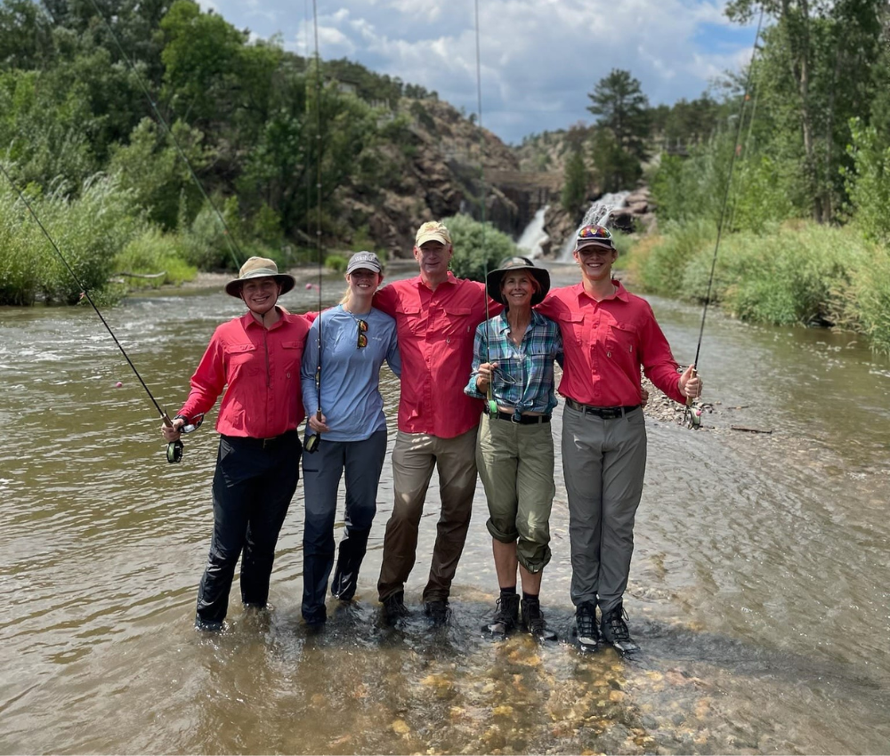 group fly fishing trips a group of anglers stand next to each other on the river