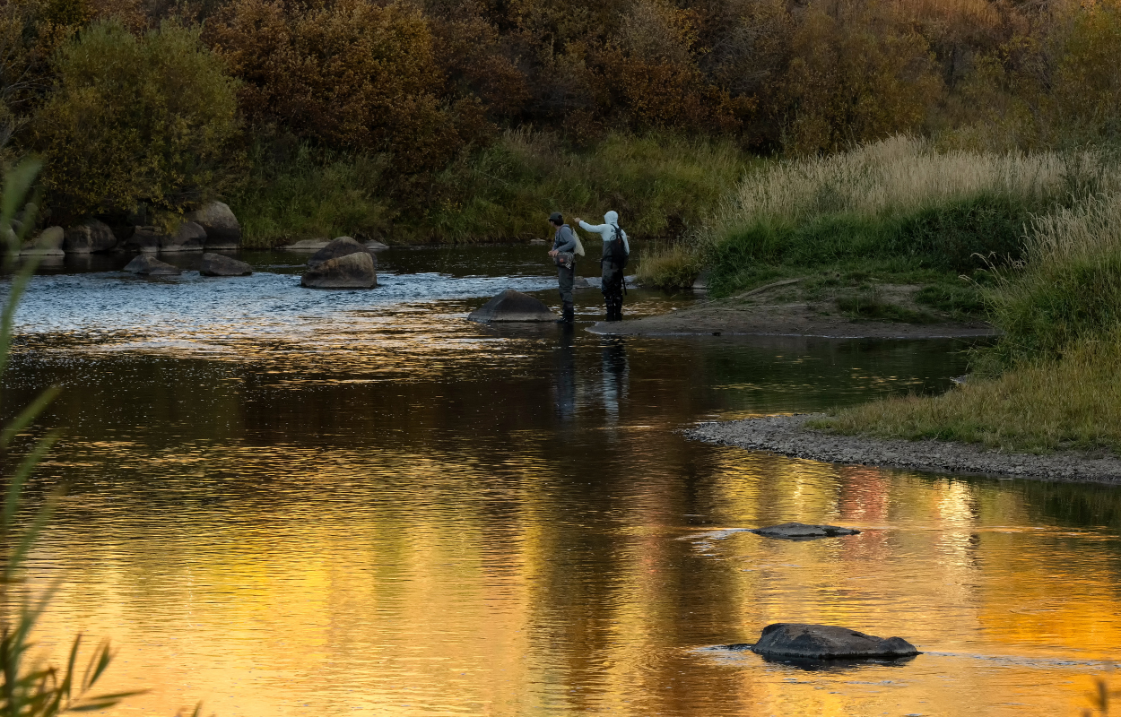 two fly fishermen on the Yampa River at sunset