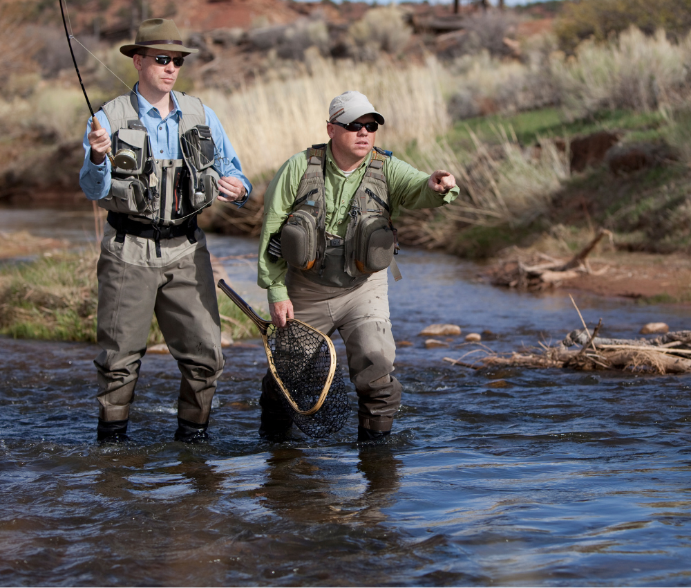 an angler and his guide fly fish in a small river in Colorado