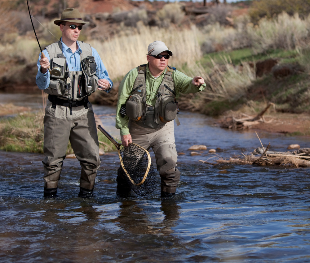 group fly fishing trips in estes park an angler and his guide fly fish in a small river in Colorado