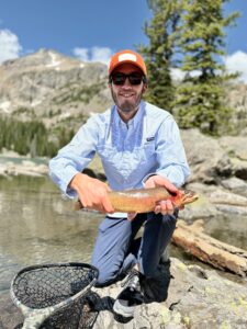 Man holding trout. 